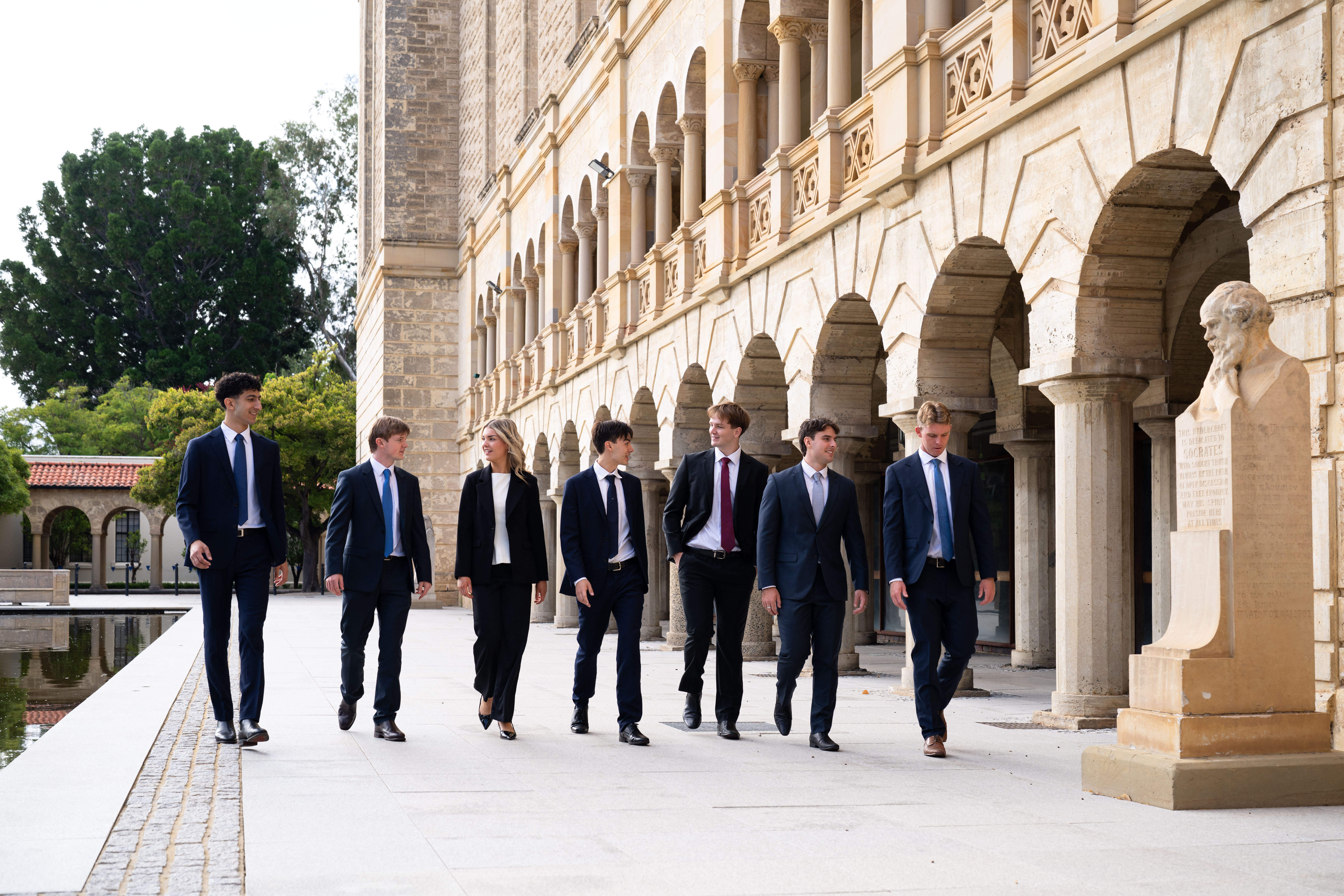 UWA Student Managed Investment Fund members walking on the UWA campus in front of Winthrop Hall
